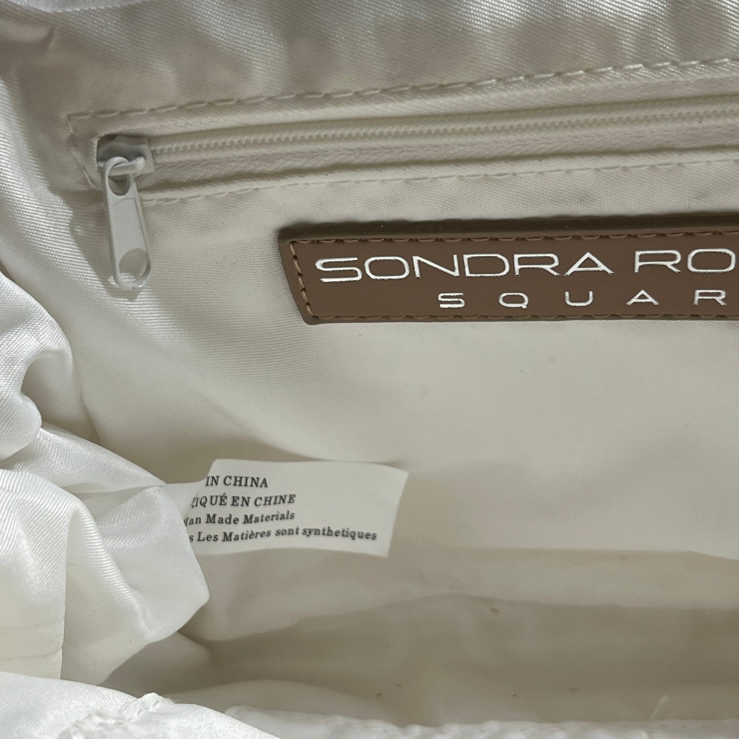 Sondra Roberts White and Tan Clutch